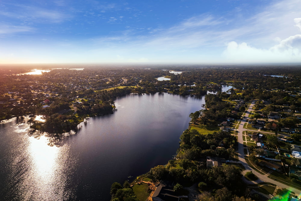 Aerial photograph captured early in the morning with a professional drone over a lake in Campbell Park Deltona, Florida.